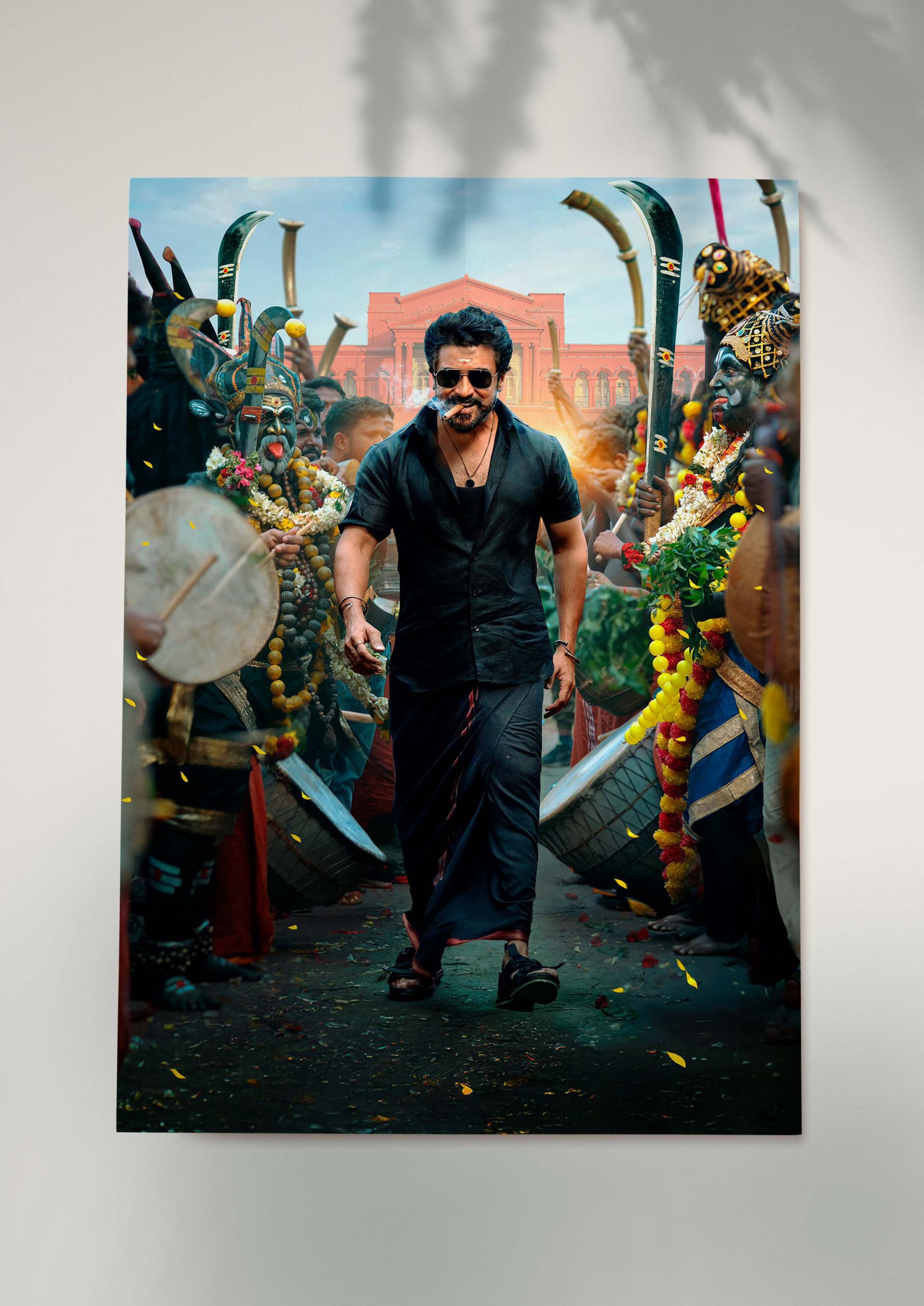 Suriya walking powerfully in Karuppu film poster with folk performers.